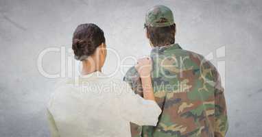 Back of soldier and wife against white wall with grunge overlay