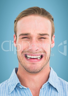 Man crying against blue background