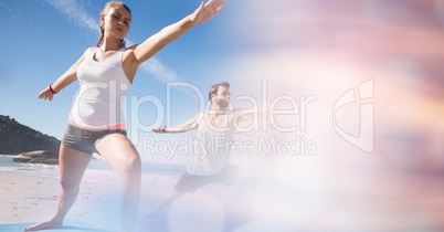 Fit man and woman exercising at beach