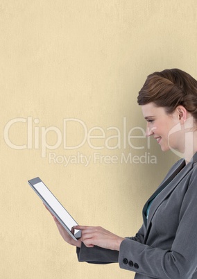 Businesswoman using tablet PC over beige background