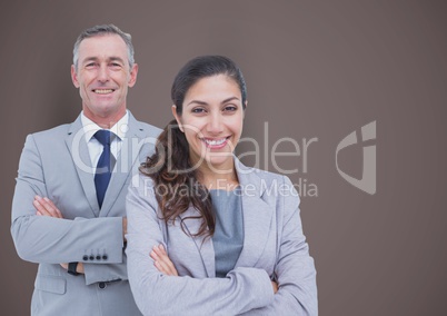 Portrait of confident business people standing arms crossed against brown background
