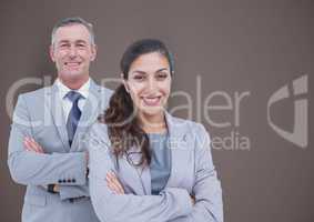Portrait of confident business people standing arms crossed against brown background
