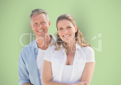 Portrait of happy couple against green background