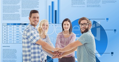 Casual business people stacking hands against graphs