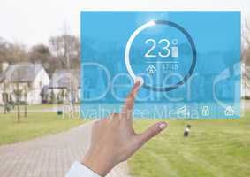 Hand touching a Home automation system temperature App Interface