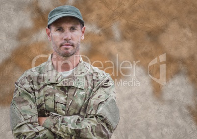 Soldier arms folded against blurry brown map and grunge overlay