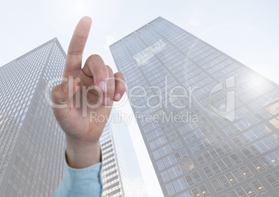 Hand pointing up with skyscrapers