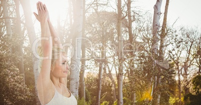 Double exposure of woman performing yoga in forest