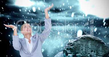 Businesswoman with arms raised against drops
