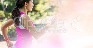 Young woman jogging with bokeh in foreground