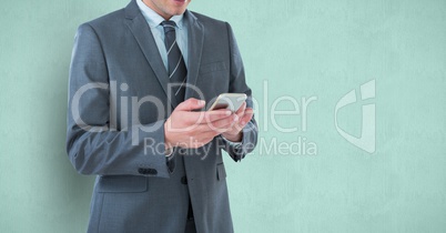 Midsection of businessman using mobile phone