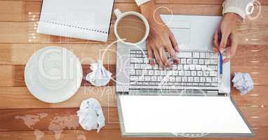 Businesswoman's hands using laptop at office desk