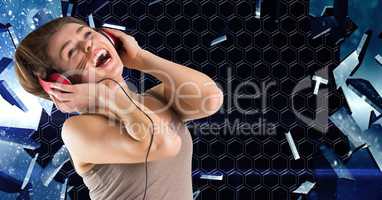 Happy woman singing while listening to music on headphones