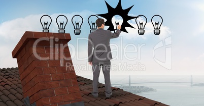 Businessman drawing lighting equipment while standing on roof