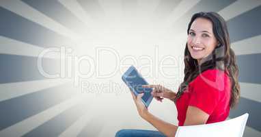 Smiling woman using tablet PC against bright background