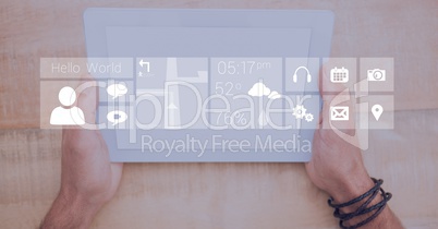 Hands holding digital tablet with icon overlay