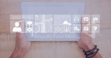 Hands holding digital tablet with icon overlay