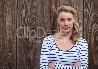 Confident female hipster standing against wooden wall