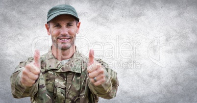 Soldier thumbs up against white wall with grunge overlay