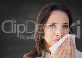 Close up of woman with tissue against grey wall