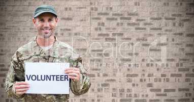 Soldier volunteer against brown brick wall