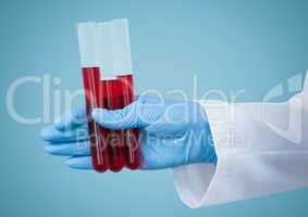 Gloved hand with red tubes against blue background