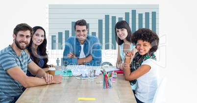 Casual business people at desk with graph in background