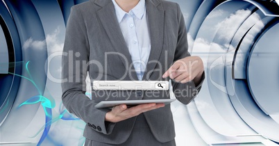 Midsection of businesswoman pointing at search page over tablet PC