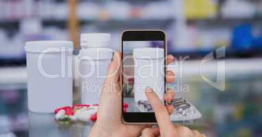 Hand photographing medicines on smart phone in pharmacy