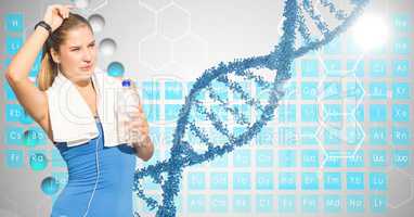 Fit woman holding water bottle against DNA structure