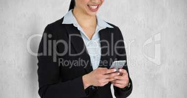 Midsection of businesswoman texting on smart phone