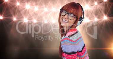 Redhead woman wearing headset against lights