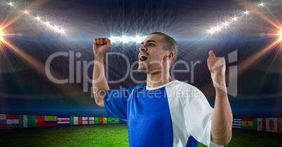 Soccer player with arms raised celebrating victory