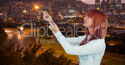 Redhead woman with arms raised in city
