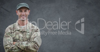 Soldier arms folded against grey background with grunge overlay