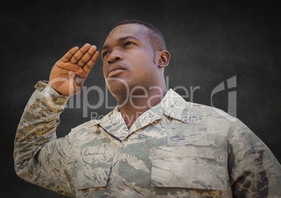 Soldier saluting against grey wall with grunge overlay