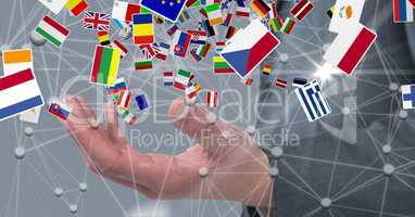 Close-up of various flags over businessman's hand