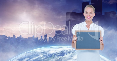 Businesswoman holding blank slate with globe and buildings in background