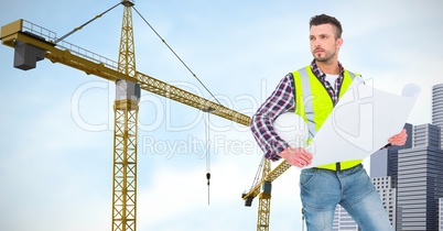 Businessman with blueprints against crane