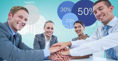 Smiling business people stacking hands
