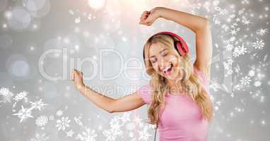 Happy woman dancing while enjoying music on headphones