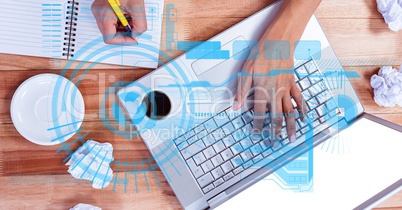 Top view of hands working at table with overlays