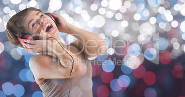 Young woman singing while listening to music on headphones