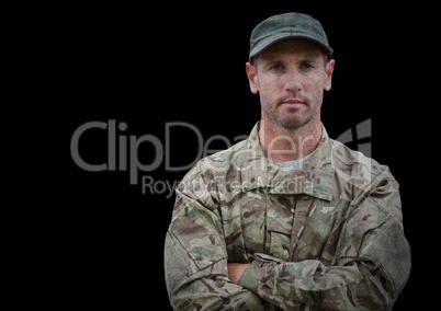Soldier with arms folded against black background with grunge overlay