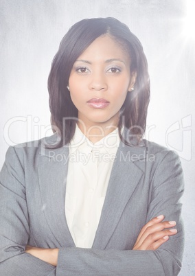 Close up of business woman arms folded with flare against white wall