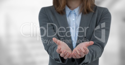 Midsection of businesswoman holding invisible product
