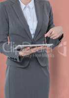 Midsection of businessman holding tablet PC