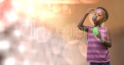 Kid blowing bubbles over blur background