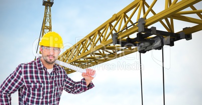 Confident architect holding blueprints by crane