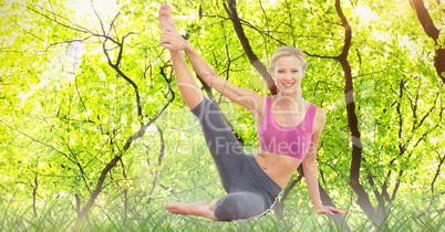 Double exposure of woman performing yoga in forest